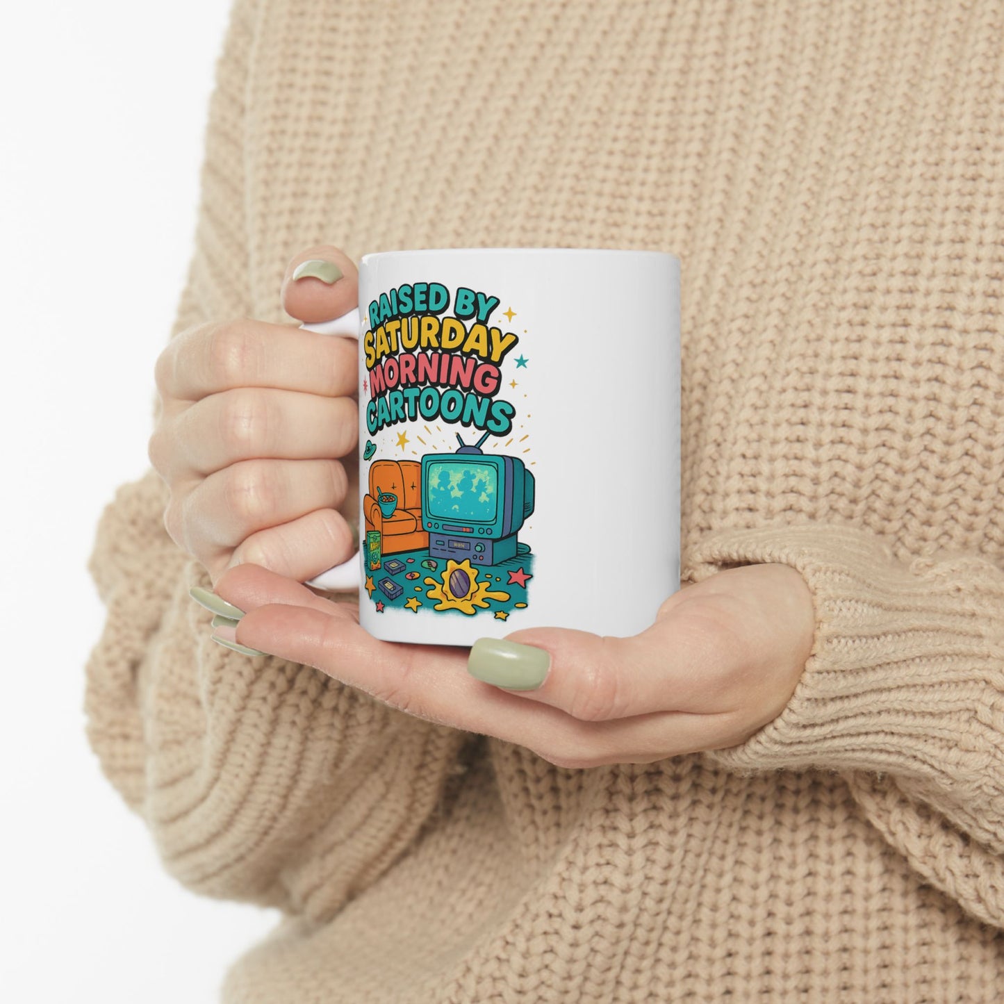 White ceramic mug with retro-style cartoon design featuring a CRT TV, cereal bowl, and couch, 90s nostalgia aesthetic.