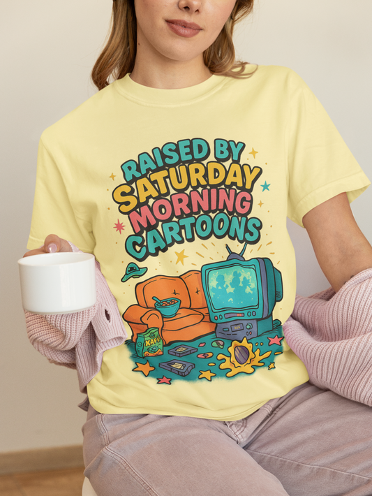Nostalgic 90s cartoon tee with a couch, cereal bowl & VHS vibes. Perfect gift for retro lovers & Saturday morning warriors. Unisex fit.